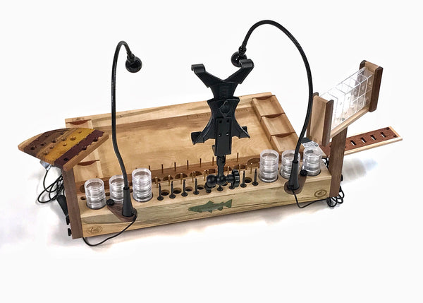 The large accessory in the back center is an A/V tool and tablet holder. It can either hold a tablet (I-pad, Surface, Etc.) for watching fly tying tutorials. By removing the tablet holder, the arm can also hold any video camera to film your fly tying.