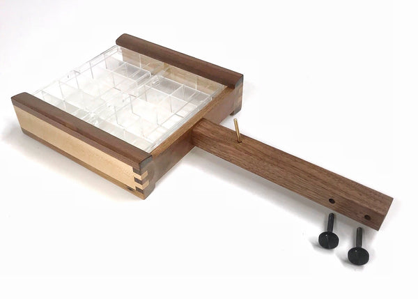 The double dubbing dispenser attaches with thumb screws and comes with a brass pin for hanging hackle pliers on. The empty dispenser boxes can be added to your order in the accessories.