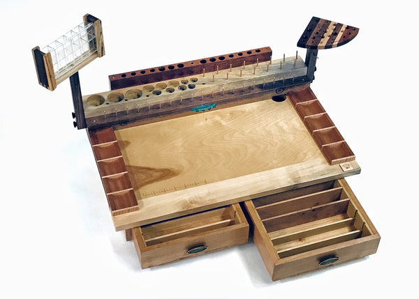 The two drawer Rainbow fly tying bench with a trash drop hole in the right rear corner. The dubbing dispenser swivel is an accessory that can be added to the bench on the opposite end of the tool swivel plate.  These can be mounted on either side of the bench using two thumb screws.