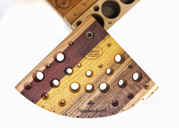 The tool swivel plate has holes for many different tools. The beveled holes make it easier to place the tool in the hole. The thirteen holes on the curved edge are for hanging newly tied flies. Every tool plate is glued up using different species of hardwoods making each one very colorful and unique.